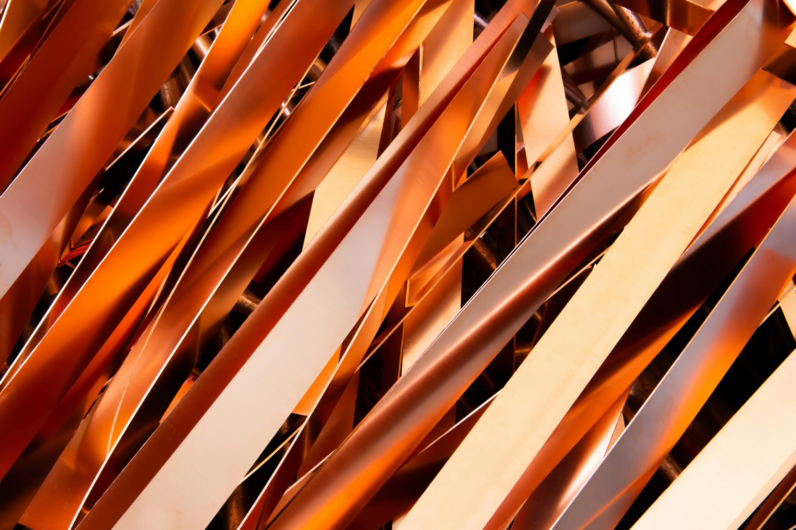 Home Close-up of intertwined metallic strips showcasing industrial recycling processes.